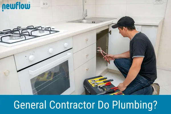 A general contractor works under a kitchen sink, showing an example related to the question of whether a general contractor can do plumbing.