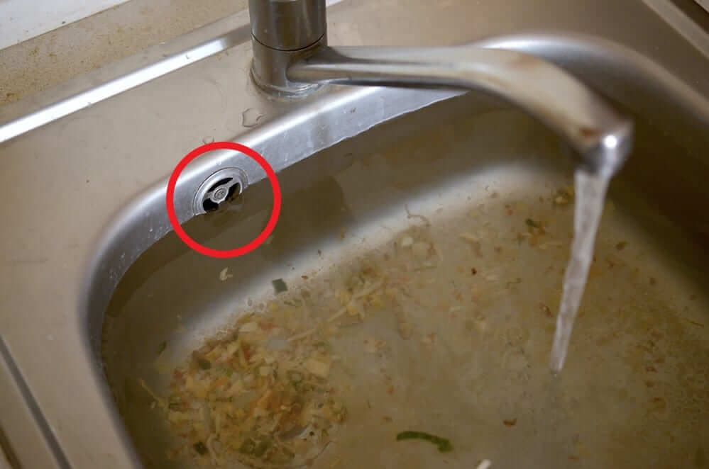 sink with water raised to overflow
