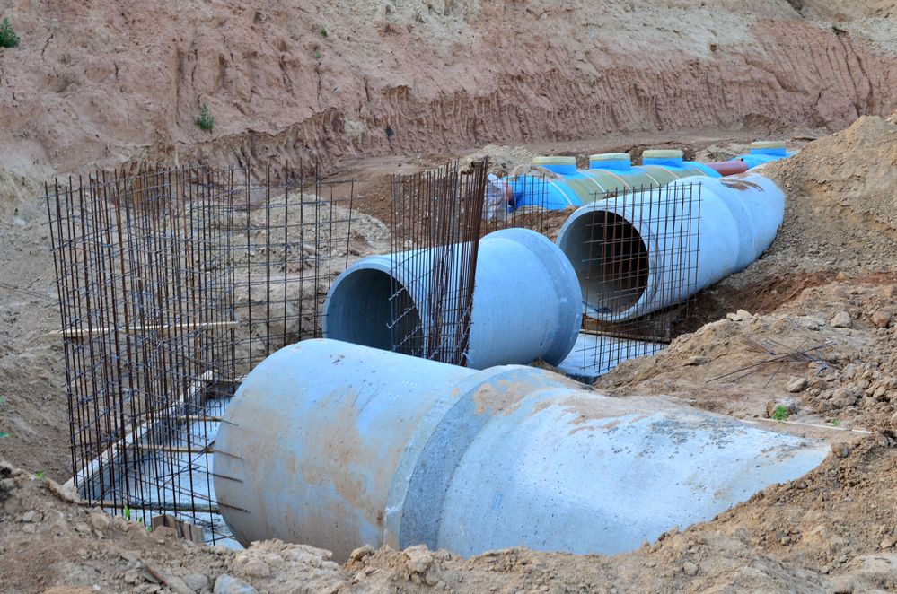 blue sewer pipes being buried.