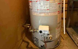 Side view of a natural gas water heater highlighting the gas control valve and thermostat.